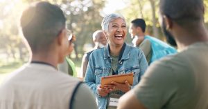 A group of volunteers connects at an outdoor community event that was coordinated with an online member directory